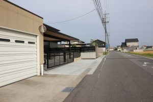 既設のガレージと連続したフェンスと電動跳ね上げ門扉です